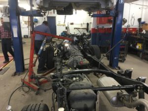 Certified mechanic putting engine in new frame.